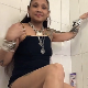A mature, Asian woman with tattoos and facial piercings takes a massive shit and a piss while standing in a bath tub. Presented in 720P HD. About 2 minutes.